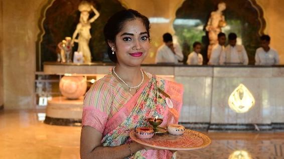 A woman holding an aarthi plate with sindoor for welcoming guests in a traditional Rajasthani way - Kaldan Samudra Palace